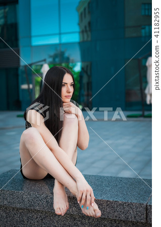 young trendy girl sitting near skyscraper 41182955