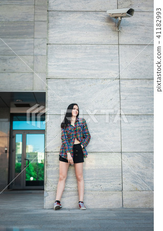 hipster teenager standing against the wall in the street hipster teenager standing against the wall in the street 41182993