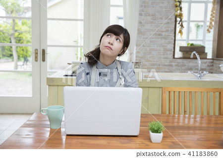 Housewives thinking in front of a computer Housewives thinking in front of a computer 41183860