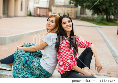 Two teenss resting on the stairs Two teenss resting on the stairs 41184587