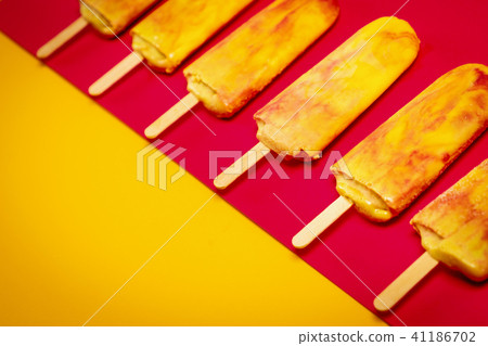 isolated yellow-red ice cream on a colorful background isolated yellow-red ice cream on a colorful background 41186702
