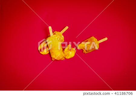 wasted delicious yellow-red ice cream on a red background 41186706