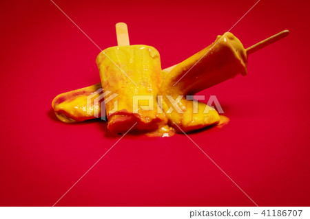 wasted delicious yellow-red ice cream on a red background 41186707