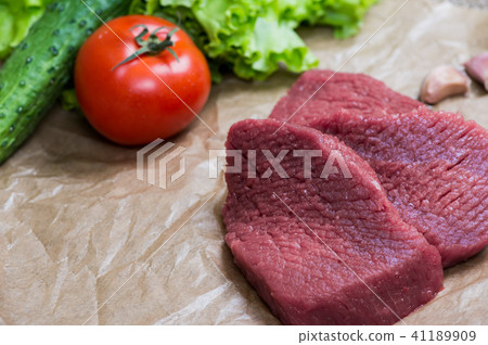 Raw meat barbecue with fresh vegetables wooden surface. Food, steak, beef bbq, tomatoes, peppers 41189909