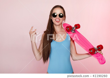 beautiful woman holding skateboard 41190260