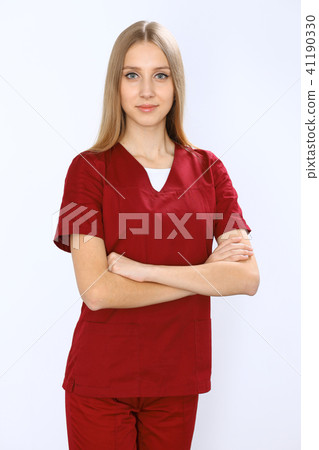 Smiling young nurse or surgeon portrait isolated over white background. Smiling young nurse or surgeon portrait isolated over white background. 41190330