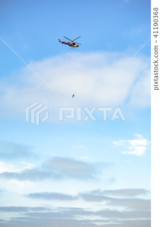 US coastguard helicopter in flight with the sky 41190368
