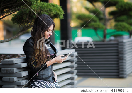 Beautiful woman talking on cellular telephone outdoor 41190932