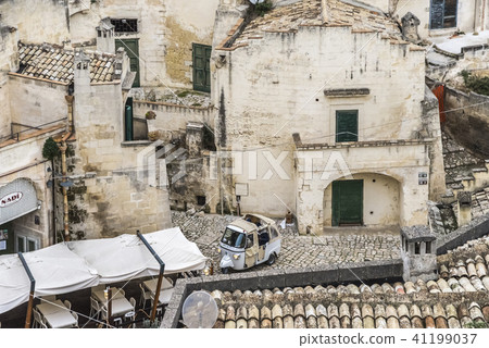 Landscape viewing Matera's cave residence and three-wheeled car 41199037