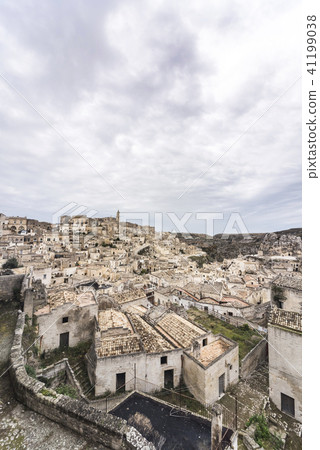 A view of the spire of the Duomo in the distance Matera cave dwelling group landscape 41199038