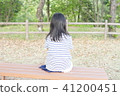 A girl sitting backwards on the bench 41200451