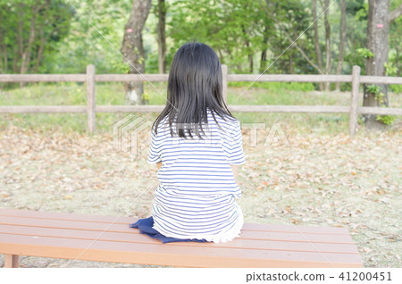 A girl sitting backwards on the bench 41200451