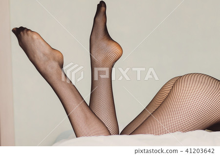 Young woman in pantyhose on bed Young woman in pantyhose on bed 41203642