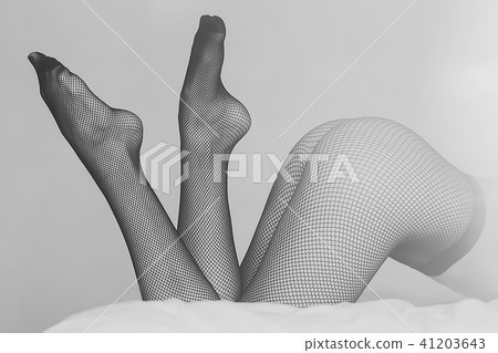 Young woman in pantyhose on bed 41203643