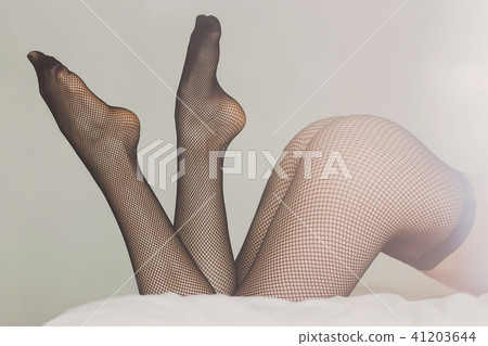 Young woman in pantyhose on bed Young woman in pantyhose on bed 41203644