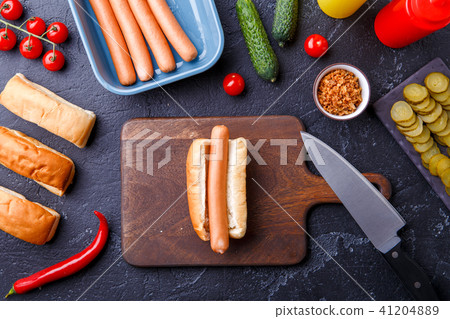 Photo on top of hotdogs on cutting board on table with sausages Photo on top of hotdogs on cutting board on table with sausages 41204889