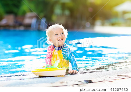 Baby in swimming pool. Family summer vacation. Baby in swimming pool. Family summer vacation. 41207480