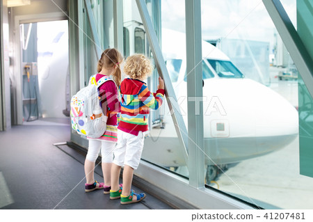 Kids travel and fly. Child at airplane in airport Kids travel and fly. Child at airplane in airport 41207481
