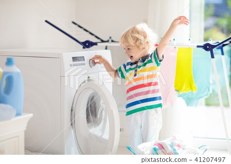Child in laundry room with washing machine 41207497