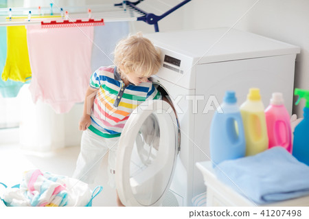 Child in laundry room with washing machine 41207498