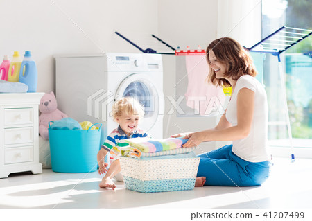 Family in laundry room with washing machine Family in laundry room with washing machine 41207499