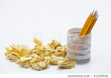 Crumpled yellow papers with pencils pot on white Crumpled yellow papers with pencils pot on white 41209592