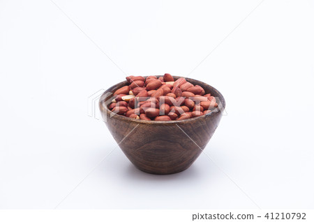 Redskin peanuts in wooden bowl isolated Redskin peanuts in wooden bowl isolated 41210792