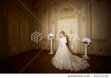 elegant stylish bride looking at rich interior in old building elegant stylish bride looking at rich interior in old building 41211230