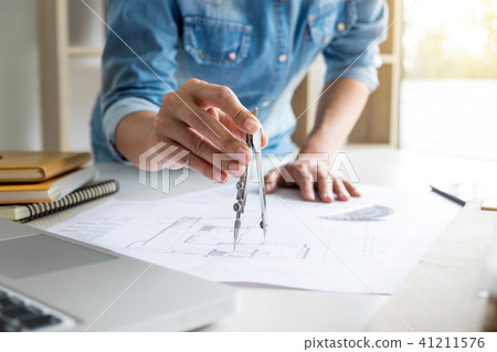 Architect working on blueprint, Engineer working with engineerin 41211576