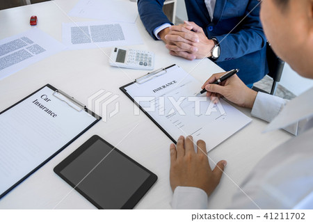 Businessman will be signing a car insurance policy, Agent man is 41211702