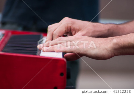 closeup of hands of musician on piano keyboard closeup of hands of musician on piano keyboard 41212238
