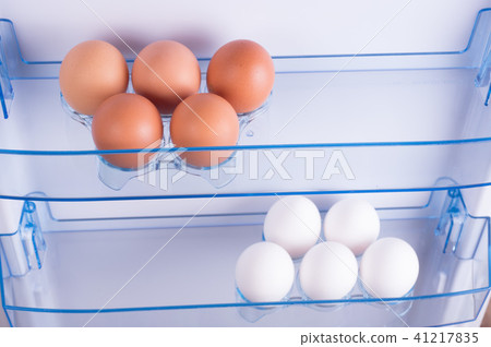 Open fridge, eggs on shelf of refrigerator door Open fridge, eggs on shelf of refrigerator door 41217835