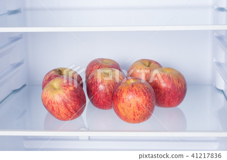 Open fridge, apples on the shelf of refrigerator Open fridge, apples on the shelf of refrigerator 41217836
