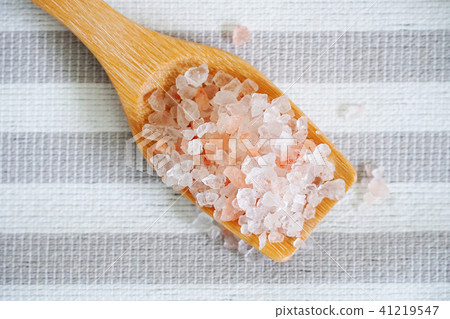 Himalayan pink salt in the spoon on the table. Himalayan pink salt in the spoon on the table. 41219547