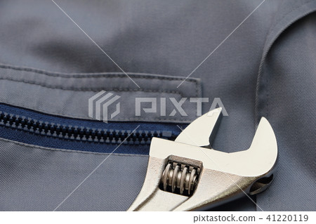 Monkey wrench placed on work clothes 41220119