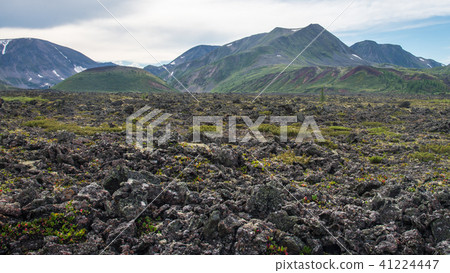 Frozen lava field in volcano valley with old Vulcan at background. Scenic landscape, Russia, Siberia Frozen lava field in volcano valley with old Vulcan at background. Scenic landscape, Russia, Siberia 41224447