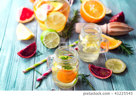 Fresh citrus lemonade in mason jars on a blue background 41225545