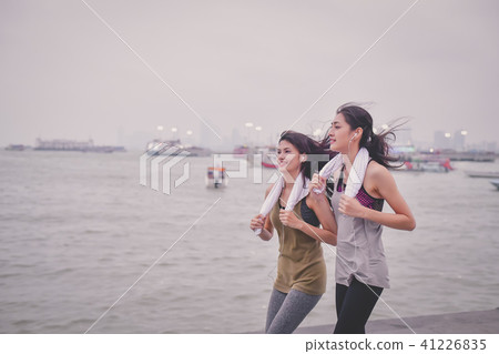 Sports concept. Beautiful girl is exercising on the beach with r 41226835