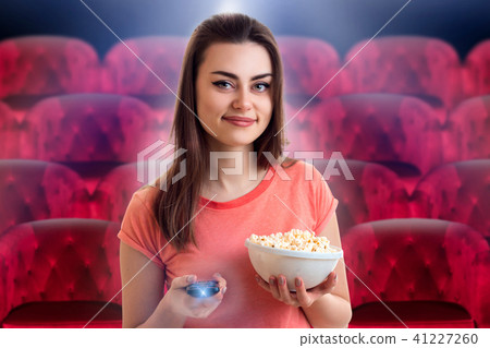 girl watching movie with pop-corn at the cinema 41227260