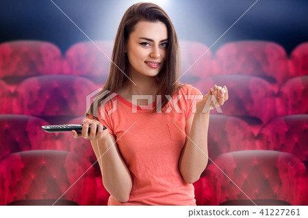 smiling pretty girl looks movie at the cinema 41227261