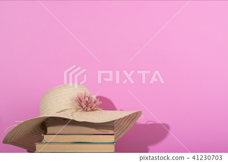 Colorful summer female fashion flat lay. Pink background, old book. Colorful summer female fashion flat lay. Pink background, old book. 41230703