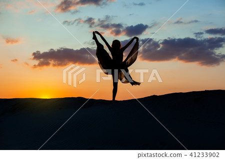 Dancer dances at sunset. Dancer dances at sunset. 41233902