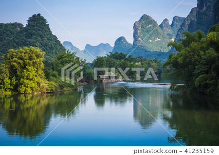 Scenic view of Yulong River among green woods 41235159