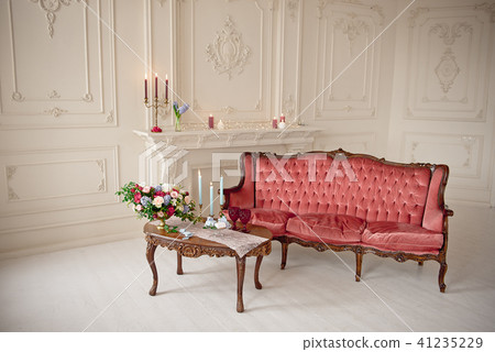 baroque style interior with red luxury sofa and table 41235229