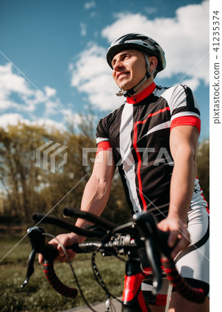 Cyclist in helmet and sportswear on sport bicycle Cyclist in helmet and sportswear on sport bicycle 41235374