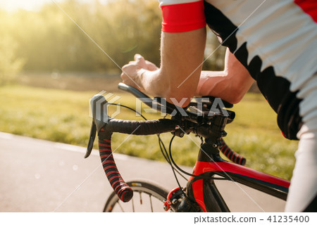 Male bycyclist in sportswear, cycling on bike path 41235400