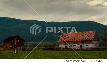 Wide shot of an abandoned log house 41235645