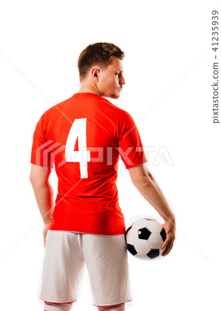 Young soccer player with ball on black background in studio. Young soccer player with ball on black background in studio. 41235939