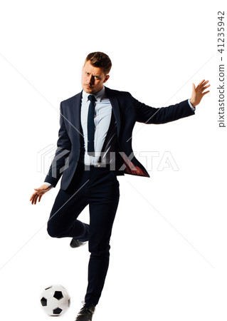 young handsome businessman manager kicking a soccer ball on white background isolated. young handsome businessman manager kicking a soccer ball on white background isolated. 41235942