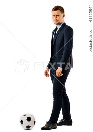 young handsome businessman manager kicking a soccer ball on white background isolated. 41235944